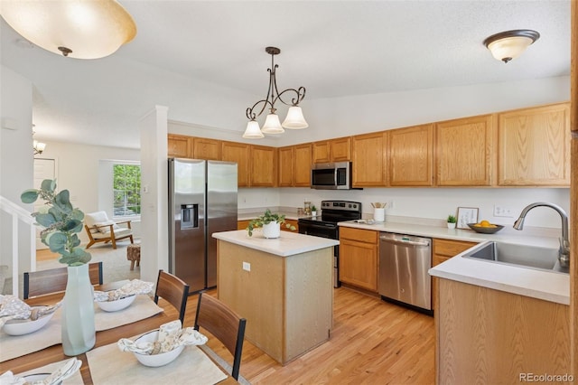 17611 Hoyt Pl, Parker, CO 80134 - kitchen with stainless steel appliances, a sink, vaulted ceiling, a center island, and light wood-type flooring