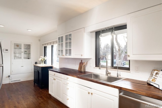 3004 S Niagara Way, Denver, CO 80224 - kitchen with butcher block counters, dishwasher, white cabinetry, and recessed lighting