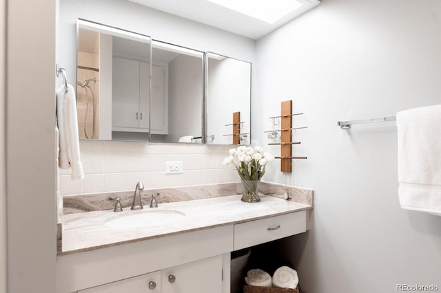 3004 S Niagara Way, Denver, CO 80224 - bathroom featuring decorative backsplash and vanity
