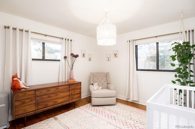 3004 S Niagara Way, Denver, CO 80224 - bedroom featuring multiple windows, a chandelier, and wood finished floors