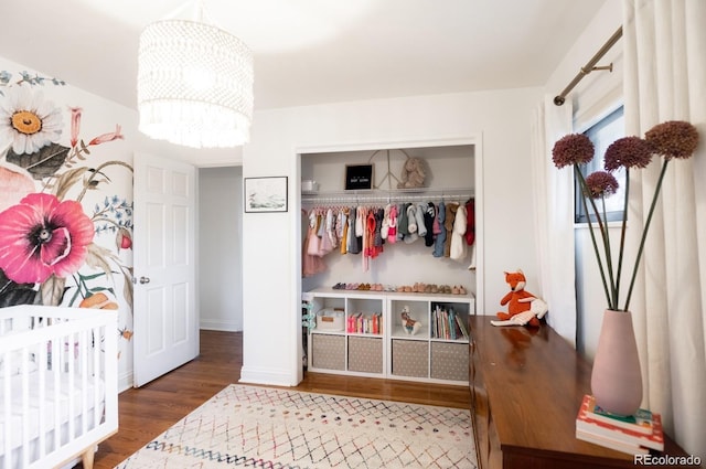 3004 S Niagara Way, Denver, CO 80224 - bedroom featuring wood finished floors, a chandelier, and a closet