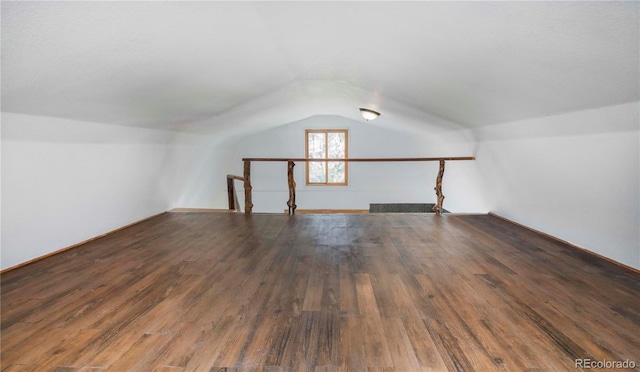 bonus room featuring wood finished floors and vaulted ceiling