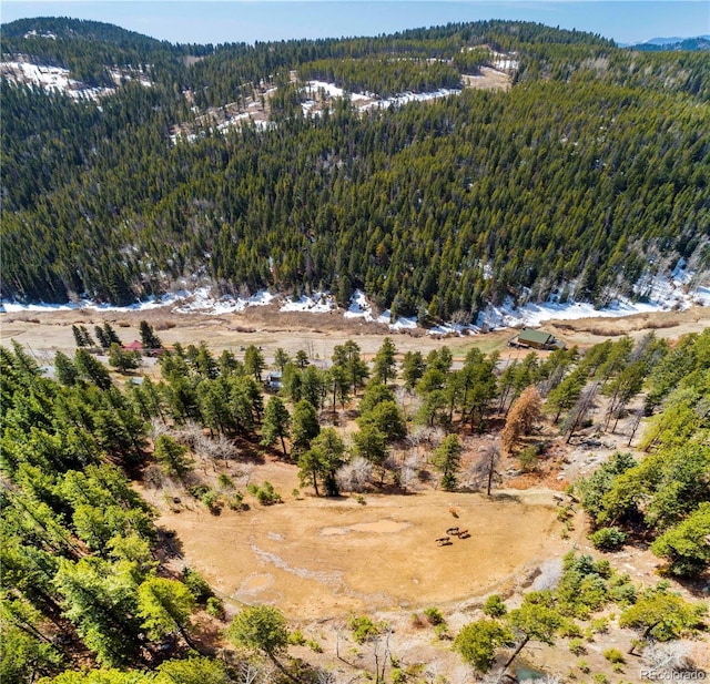 bird's eye view with a mountain view and a forest view