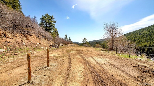 view of road featuring a wooded view
