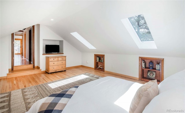 bedroom featuring recessed lighting, baseboards, lofted ceiling with skylight, and light wood-style floors