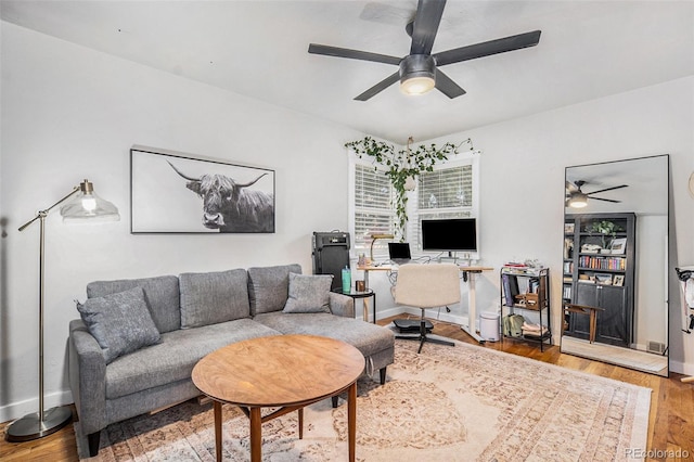 living room featuring wood-type flooring and ceiling fan