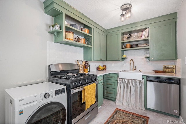 kitchen with sink, green cabinets, appliances with stainless steel finishes, backsplash, and washer / clothes dryer