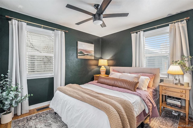 bedroom with hardwood / wood-style flooring and ceiling fan