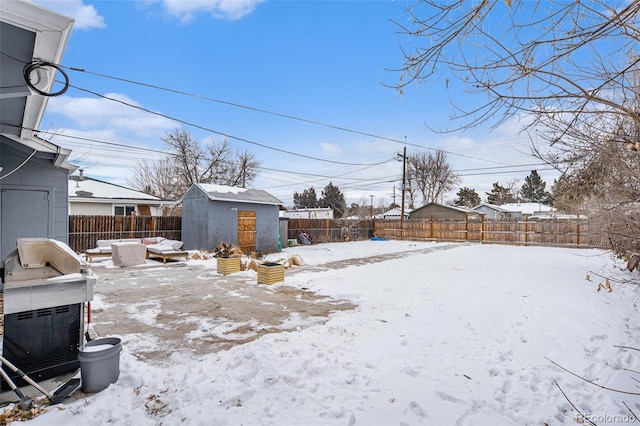 yard layered in snow with a shed