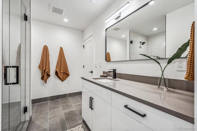 bathroom featuring an enclosed shower, tile patterned floors, and vanity