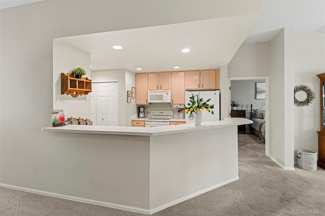 8009 S Algonquian Ct, Aurora, CO 80016 - kitchen with white appliances, light colored carpet, light countertops, a peninsula, and recessed lighting