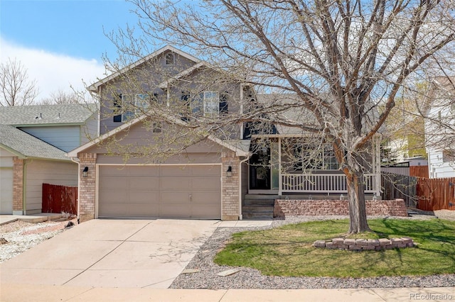 traditional home with fence, driveway, a porch, brick siding, and a garage