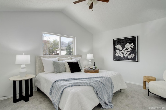 bedroom with lofted ceiling, a ceiling fan, and carpet flooring