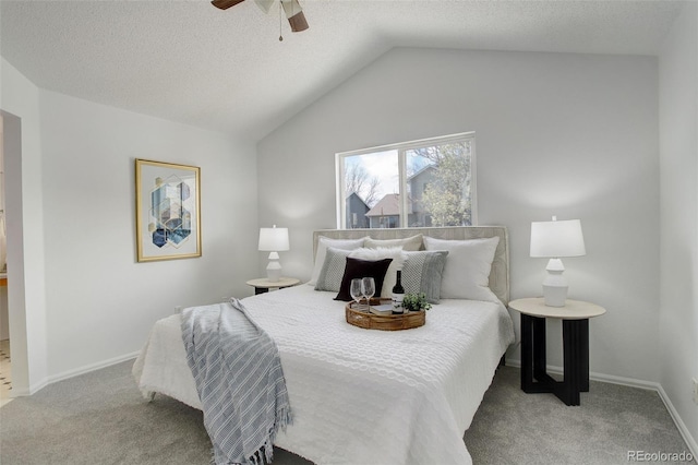 carpeted bedroom featuring vaulted ceiling, a ceiling fan, a textured ceiling, and baseboards