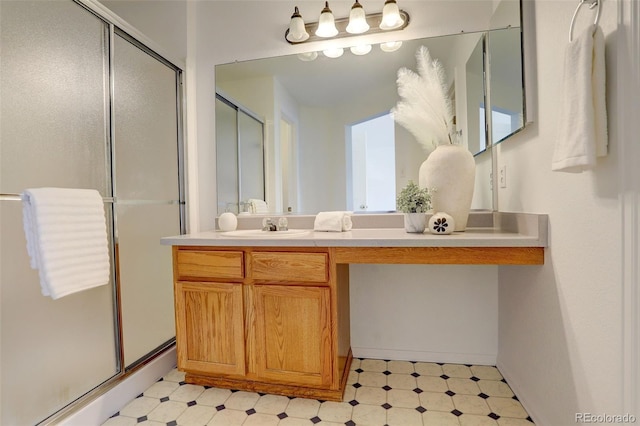 bathroom with a shower stall, tile patterned floors, and vanity