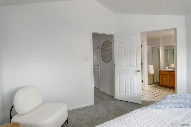 bedroom featuring baseboards, lofted ceiling, and light colored carpet