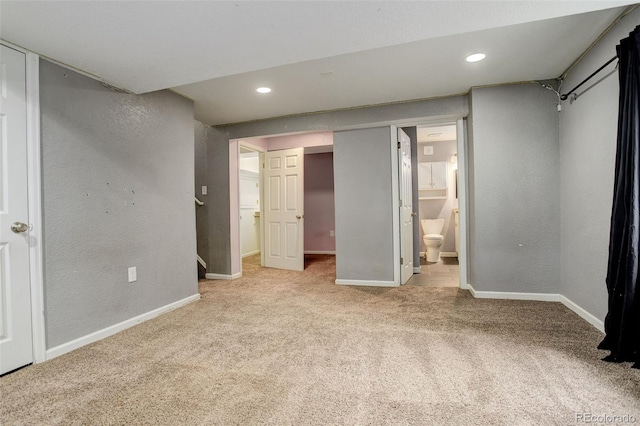 unfurnished bedroom with recessed lighting, baseboards, a textured wall, and carpet
