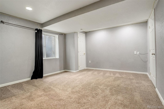 interior space with recessed lighting, carpet, baseboards, and a textured wall