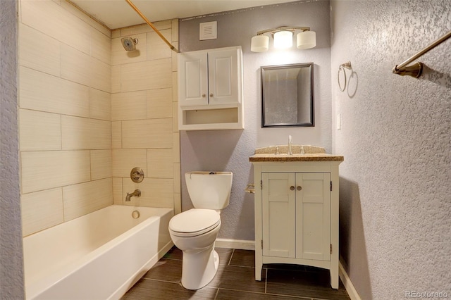 bathroom with vanity, toilet, bathtub / shower combination, a textured wall, and wood tiled floor