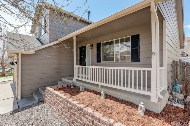 property entrance with fence and covered porch