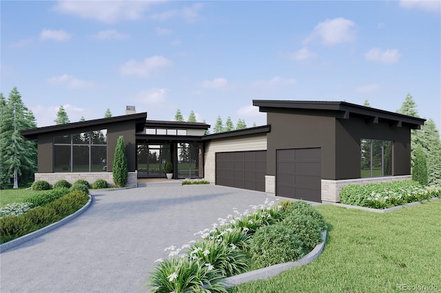 contemporary home featuring a garage and a front lawn