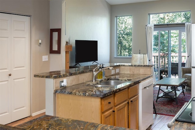77 Spyglass Ln Unit 77, Silverthorne, CO 80498 - kitchen with white dishwasher, dark stone countertops, and light wood-style flooring