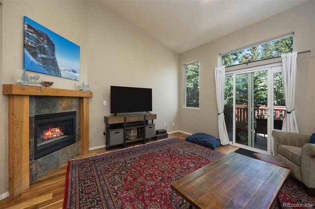 77 Spyglass Ln Unit 77, Silverthorne, CO 80498 - living area with a tiled fireplace, wood finished floors, and lofted ceiling