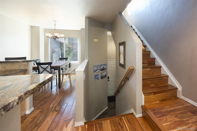 77 Spyglass Ln Unit 77, Silverthorne, CO 80498 - staircase with hardwood / wood-style floors and a chandelier