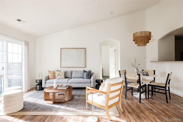 living room featuring hardwood / wood-style flooring and vaulted ceiling