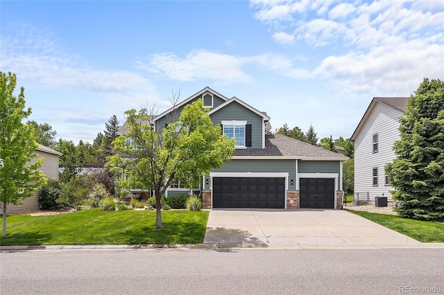 10802 W Indore Dr, Littleton, CO 80127 - view of front facade with a front lawn, driveway, central air condition unit, stone siding, and an attached garage