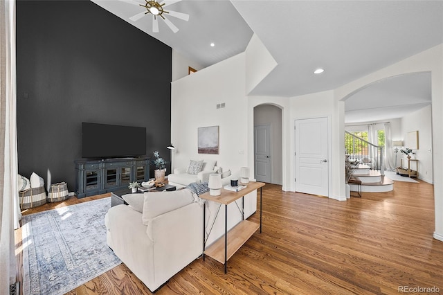 10802 W Indore Dr, Littleton, CO 80127 - living area with arched walkways, a ceiling fan, high vaulted ceiling, wood finished floors, and baseboards