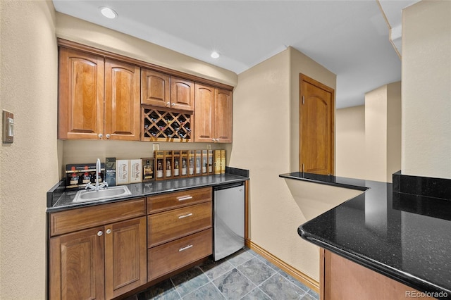 10802 W Indore Dr, Littleton, CO 80127 - indoor wet bar with refrigerator, baseboards, and recessed lighting