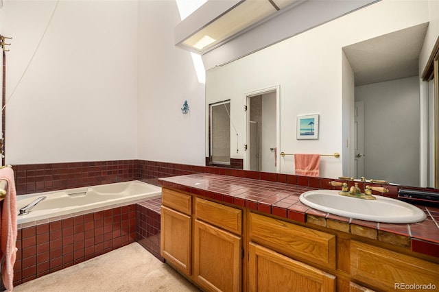 9400 E Iliff Ave Unit 88, Denver, CO 80231 - bathroom featuring a garden tub and vanity
