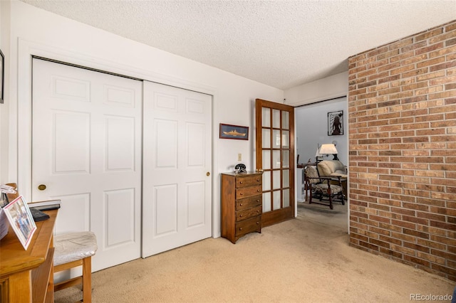 9400 E Iliff Ave Unit 88, Denver, CO 80231 - sitting room featuring french doors, light carpet, and a textured ceiling