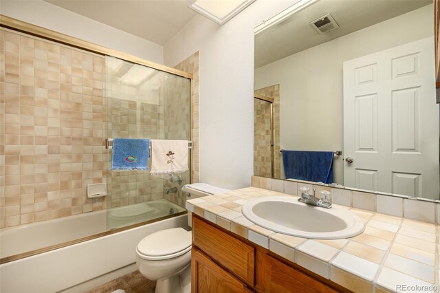 9400 E Iliff Ave Unit 88, Denver, CO 80231 - full bathroom with vanity, toilet, and shower / bath combination with glass door