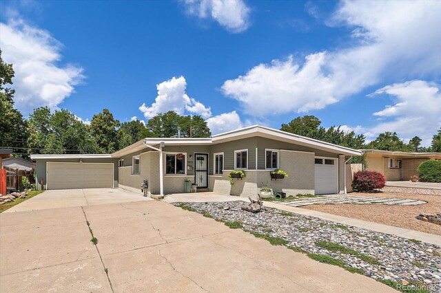 5975 Dover St, Arvada, CO 80004 - ranch-style home with a garage, driveway, and brick siding