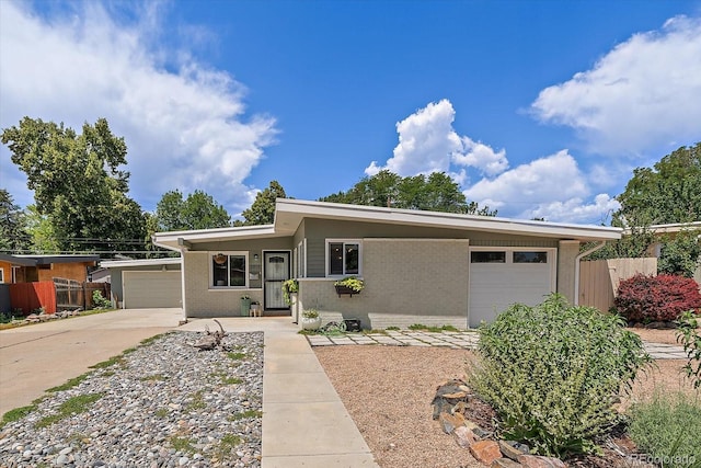 5975 Dover St, Arvada, CO 80004 - view of front of home featuring an attached garage, driveway, and brick siding