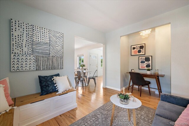 5975 Dover St, Arvada, CO 80004 - living room with light wood finished floors and a chandelier