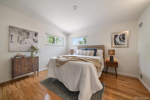 5975 Dover St, Arvada, CO 80004 - bedroom featuring light wood-style flooring and vaulted ceiling
