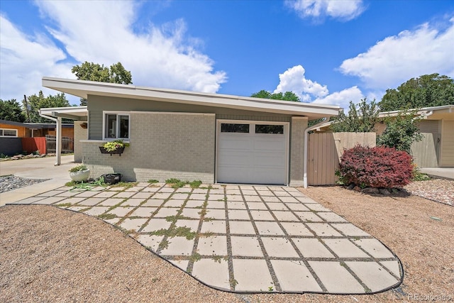 5975 Dover St, Arvada, CO 80004 - view of front of house with a garage, brick siding, and concrete driveway