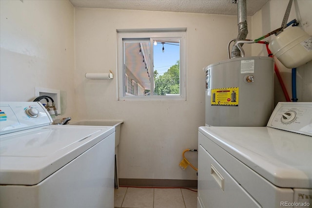 5975 Dover St, Arvada, CO 80004 - washroom featuring electric water heater, washing machine and dryer, and light tile patterned floors