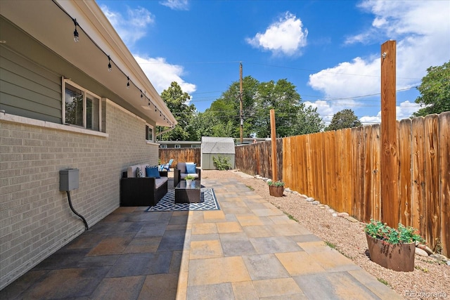 5975 Dover St, Arvada, CO 80004 - fenced backyard with an outdoor hangout area, a patio, and a storage unit