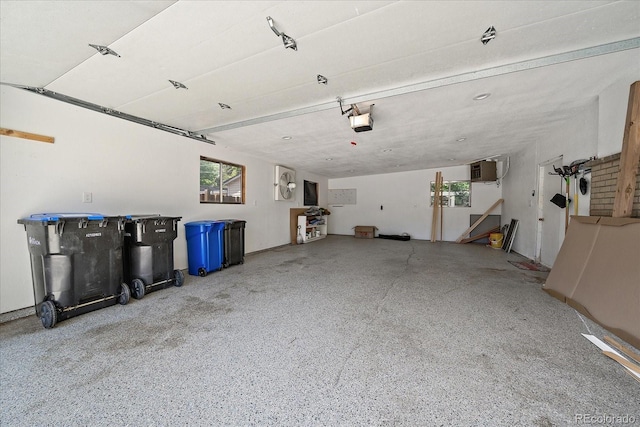 5975 Dover St, Arvada, CO 80004 - garage featuring a garage door opener and a wall mounted air conditioner