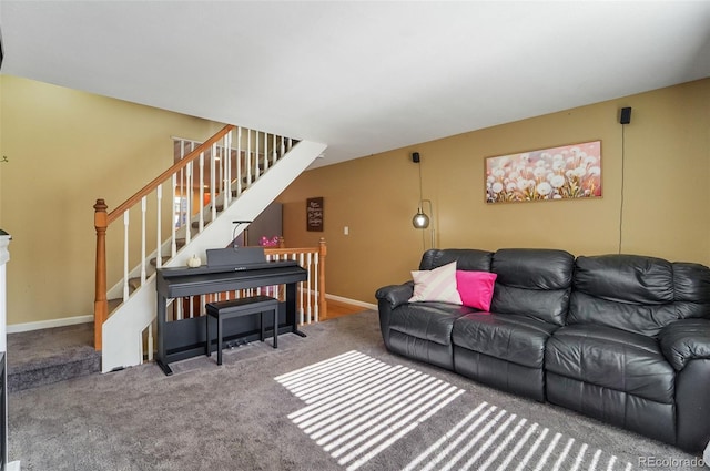carpeted living area with baseboards and stairs