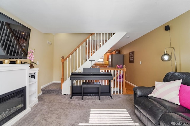 carpeted living room with baseboards and stairs