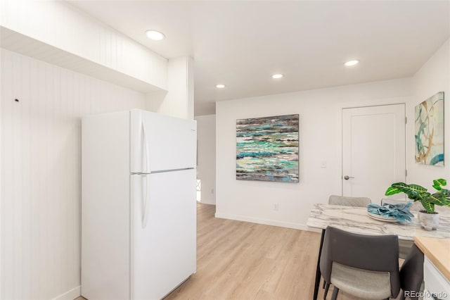 kitchen with white fridge and light hardwood / wood-style floors