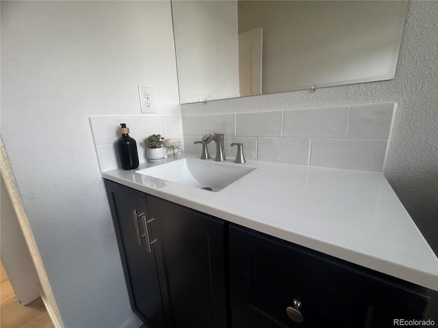 bathroom featuring decorative backsplash and vanity