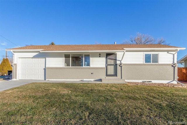 ranch-style home featuring a garage, driveway, a front lawn, and brick siding