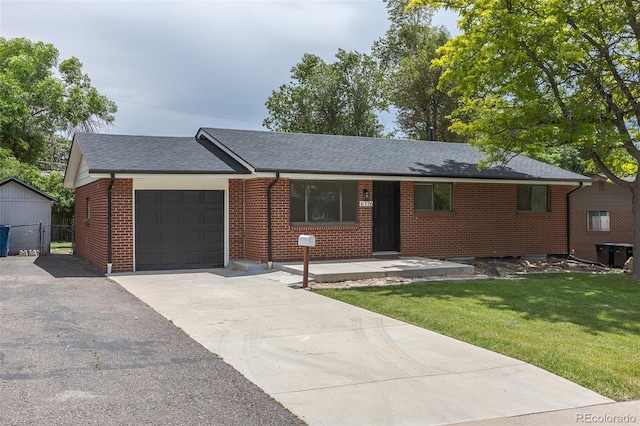 6176 Ammons St, Arvada, CO 80004 - ranch-style house with a garage, brick siding, a shingled roof, driveway, and a gate