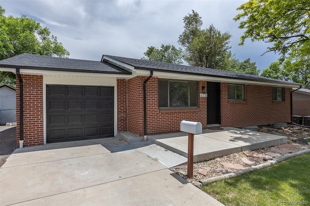 6176 Ammons St, Arvada, CO 80004 - ranch-style home with an attached garage, brick siding, and concrete driveway